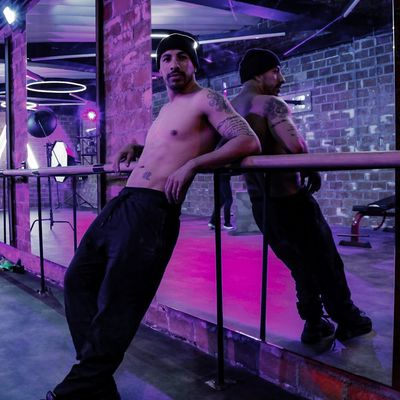 Athletic shoes on a dark surface with violet neon.